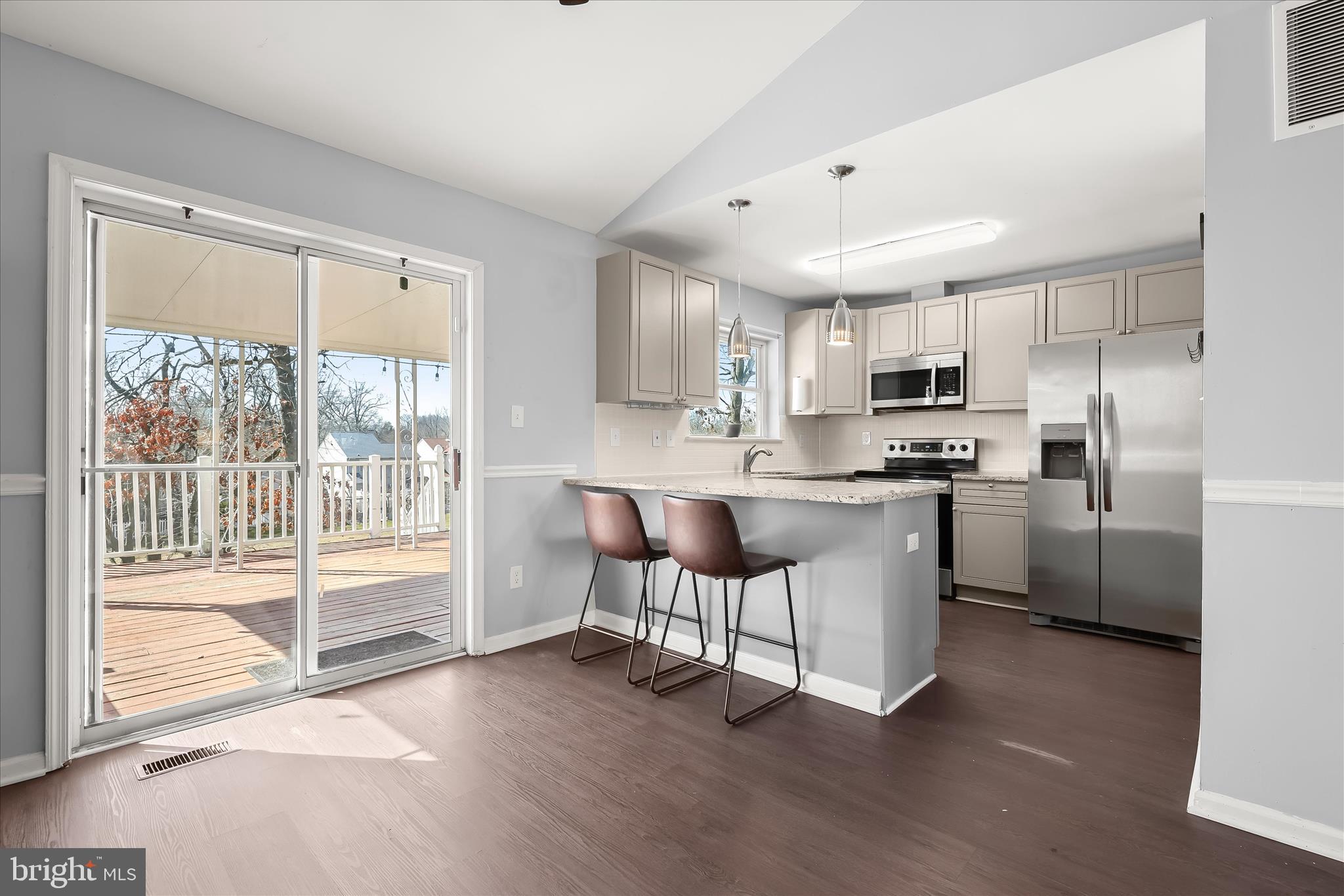 8624 Castlemill Circle Nottingham, MD 21236 - Photo 10 of 34 a kitchen with kitchen island white cabinets and refrigerator