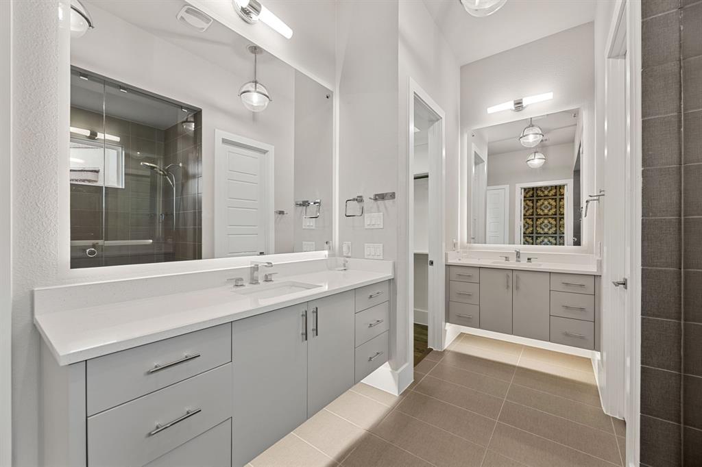7854 Element Avenue Plano, TX 75024 - Photo 27 of 38 Bathroom with two vanities, a stall shower, and tile patterned floors