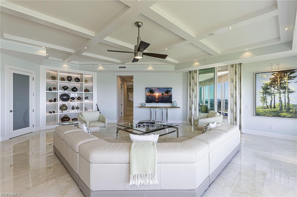295 Grande Way, Unit PH2 Naples, FL 34110 - Photo 11 of 45 a living room with furniture kitchen view and a large window