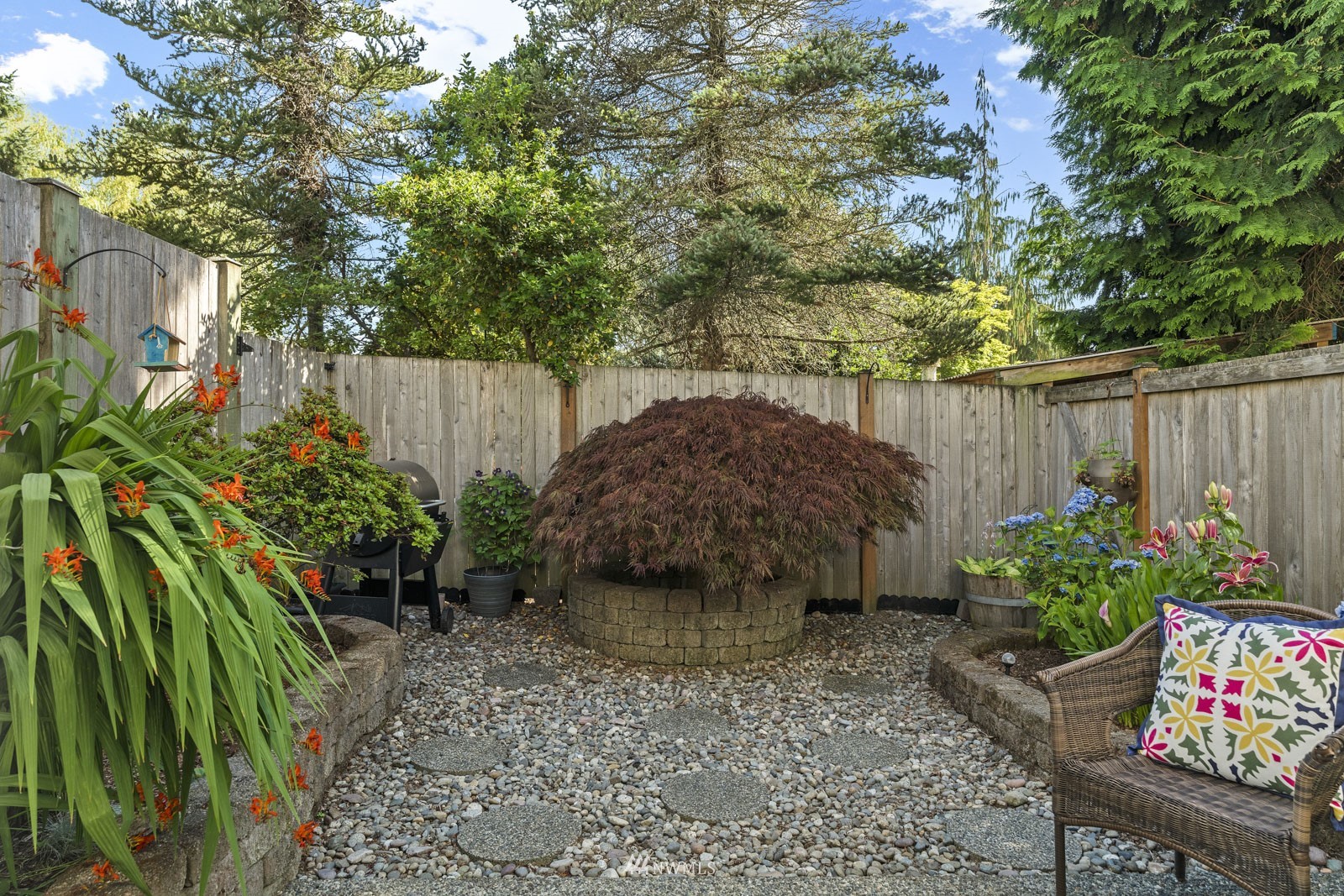 23908 Bothell Everett Highway, Unit C5 Bothell, WA 98021 - Photo 16 of 40 a view of a garden filled with plants and large trees