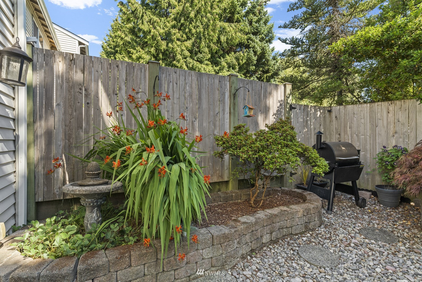 23908 Bothell Everett Highway, Unit C5 Bothell, WA 98021 - Photo 17 of 40 a view of a backyard with potted plants and wooden fence