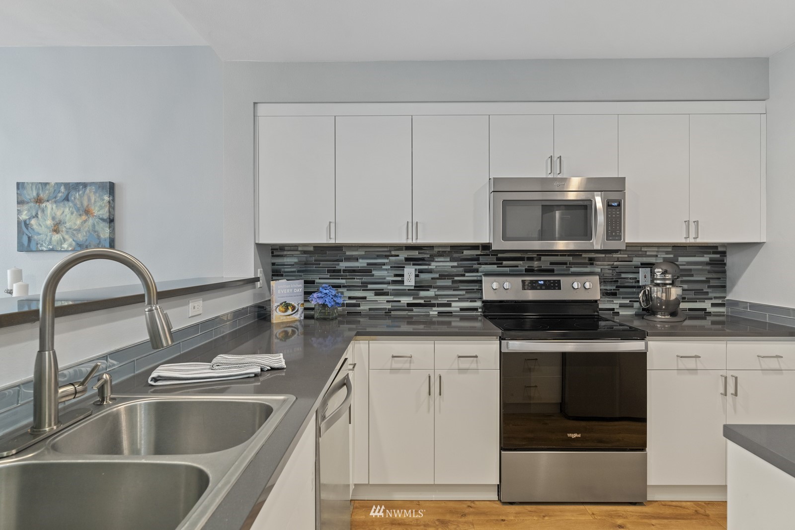23908 Bothell Everett Highway, Unit C5 Bothell, WA 98021 - Photo 10 of 40 a kitchen with stainless steel appliances granite countertop a sink a stove and a microwave