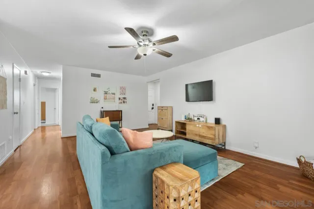 a kitchen with stainless steel appliances kitchen island granite countertop a table chairs and a refrigerator