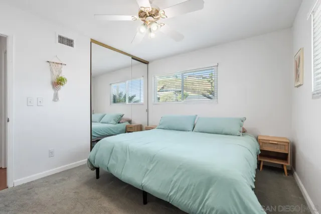 a living room with furniture a chandelier and a window
