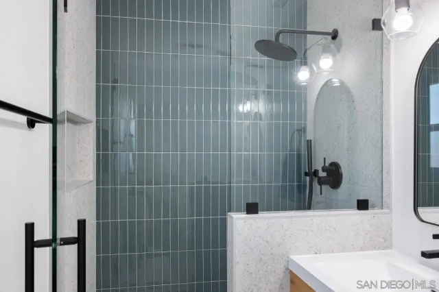 a bathroom with a sink mirror vanity and bathtub