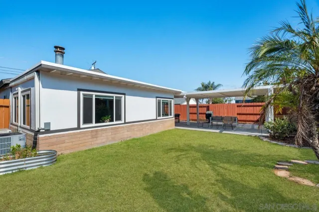 a outdoor patio with table and chairs
