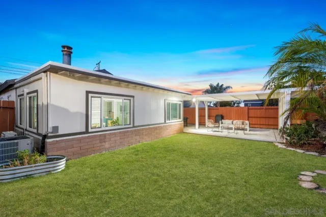 a view of a patio with couches chairs and wooden floor