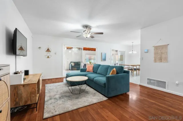 a living room with furniture and a dining table