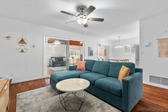 a living room with furniture and a dining table
