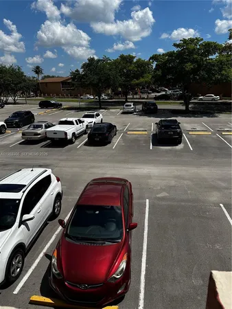 a view of a parking area with cars