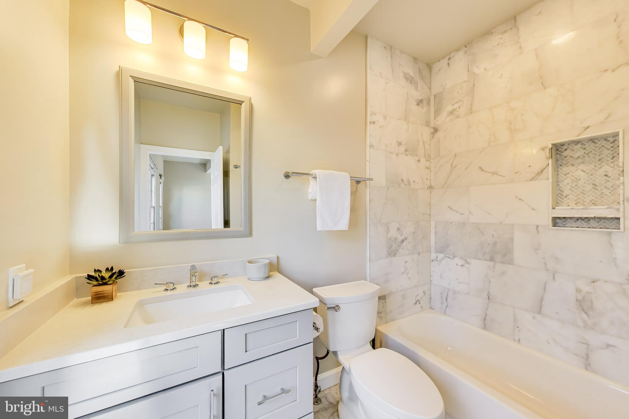 9200 Linden Grove Court Silver Spring, MD 20910 - Photo 25 of 72 a bathroom with a sink toilet vanity and shower