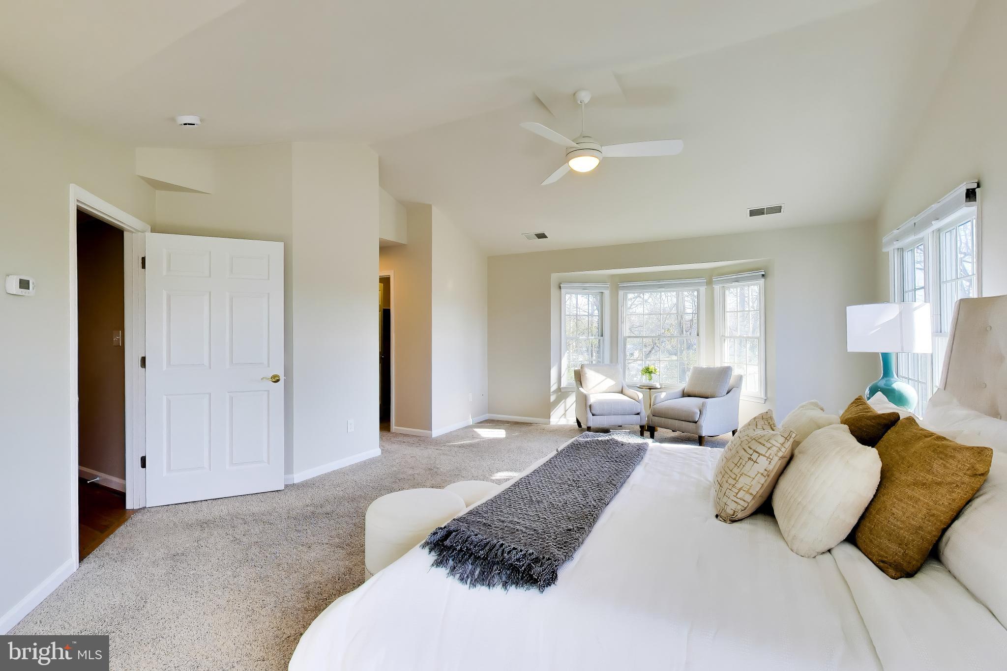 9200 Linden Grove Court Silver Spring, MD 20910 - Photo 29 of 72 a bedroom with a bed a couch and large window