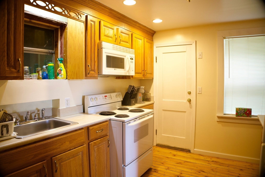 96 Harris Street Methuen, MA 01844 - Photo 14 of 19 a kitchen with stainless steel appliances granite countertop a sink stove and refrigerator
