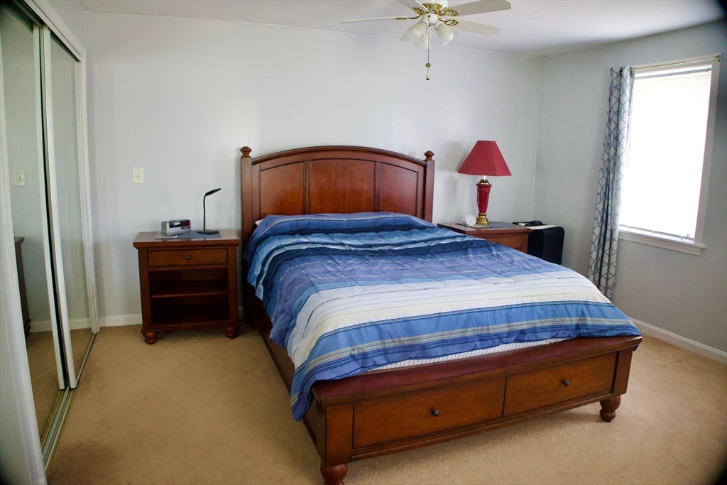 96 Harris Street Methuen, MA 01844 - Photo 6 of 19 a bedroom with a bed and a chandelier