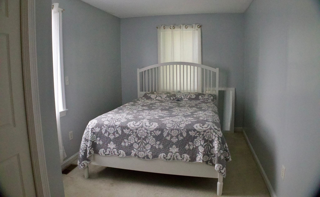 96 Harris Street Methuen, MA 01844 - Photo 7 of 19 a bed sitting in a bedroom next to a window