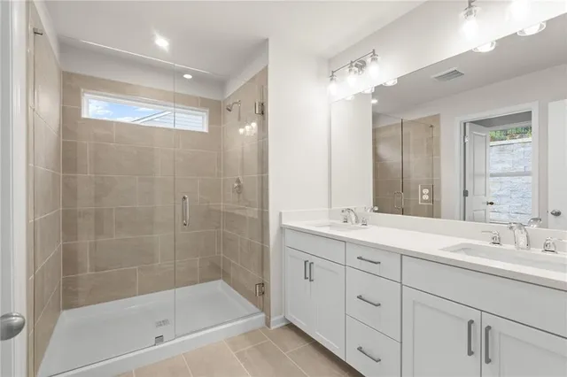 a bathroom with a bathtub shower sink and mirror