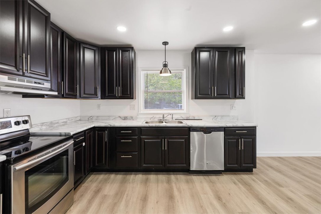 629 Little Meadow Drive Riverside, OH 45404 - Photo 16 of 48 This modern kitchen features stylish dark cabinetry and essential stainless steel appliances.