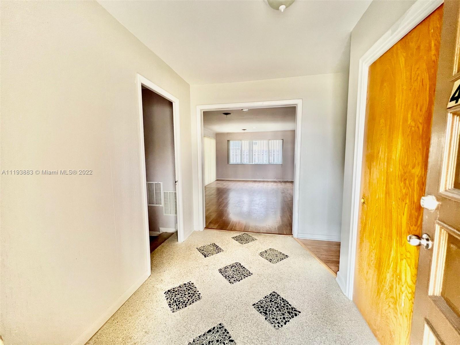4407 Arthur Street Hollywood, FL 33021 - Photo 12 of 25 a bedroom with a bed and wooden floor