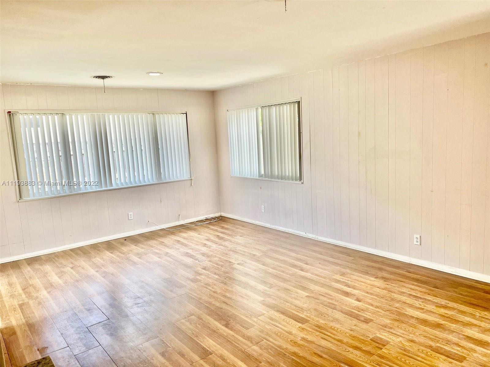 4407 Arthur Street Hollywood, FL 33021 - Photo 14 of 25 a view of an empty room with wooden floor and a window