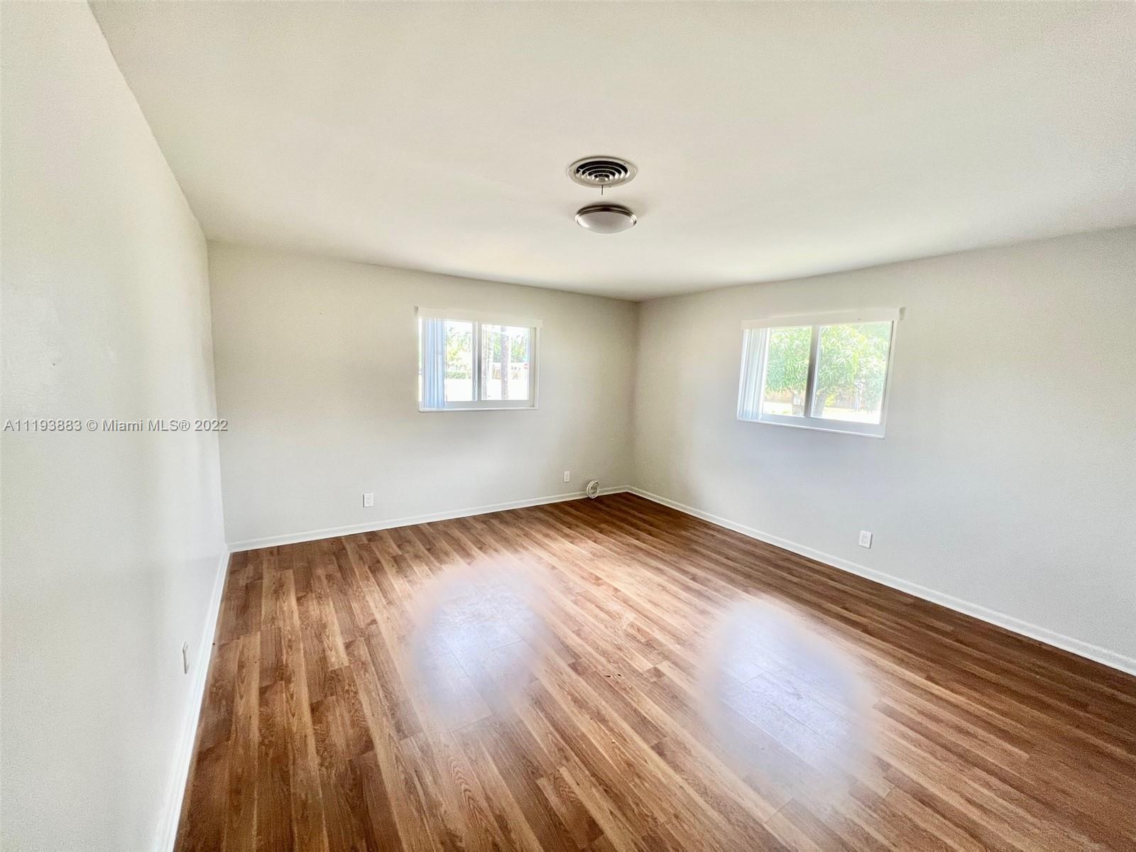 4407 Arthur Street Hollywood, FL 33021 - Photo 15 of 25 an empty room with wooden floor and windows