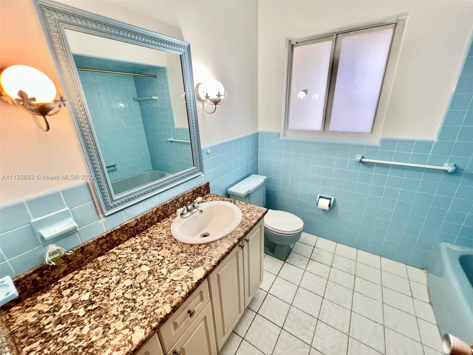 4407 Arthur Street Hollywood, FL 33021 - Photo 17 of 25 a bathroom with a sink a toilet and mirror