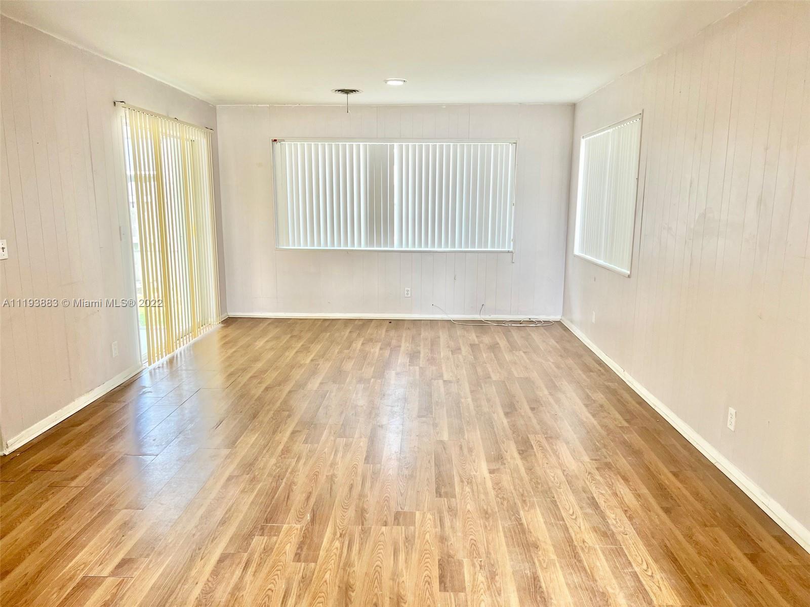 4407 Arthur Street Hollywood, FL 33021 - Photo 6 of 25 a view of an empty room with wooden floor and a window