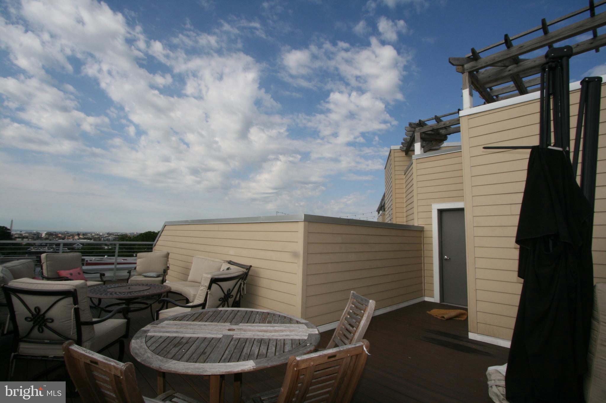 2550 17th Street Northwest, Unit 612 Washington, DC 20009 - Photo 31 of 55 a balcony with table and chairs