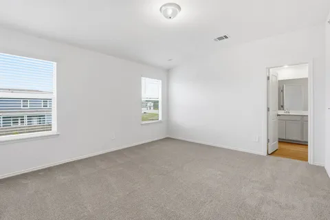 an empty room with windows and closet