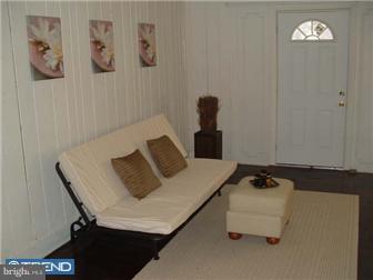 1806 44th Street Pennsauken, NJ 08110 - Photo 3 of 12 a bedroom with a bed and a table in it