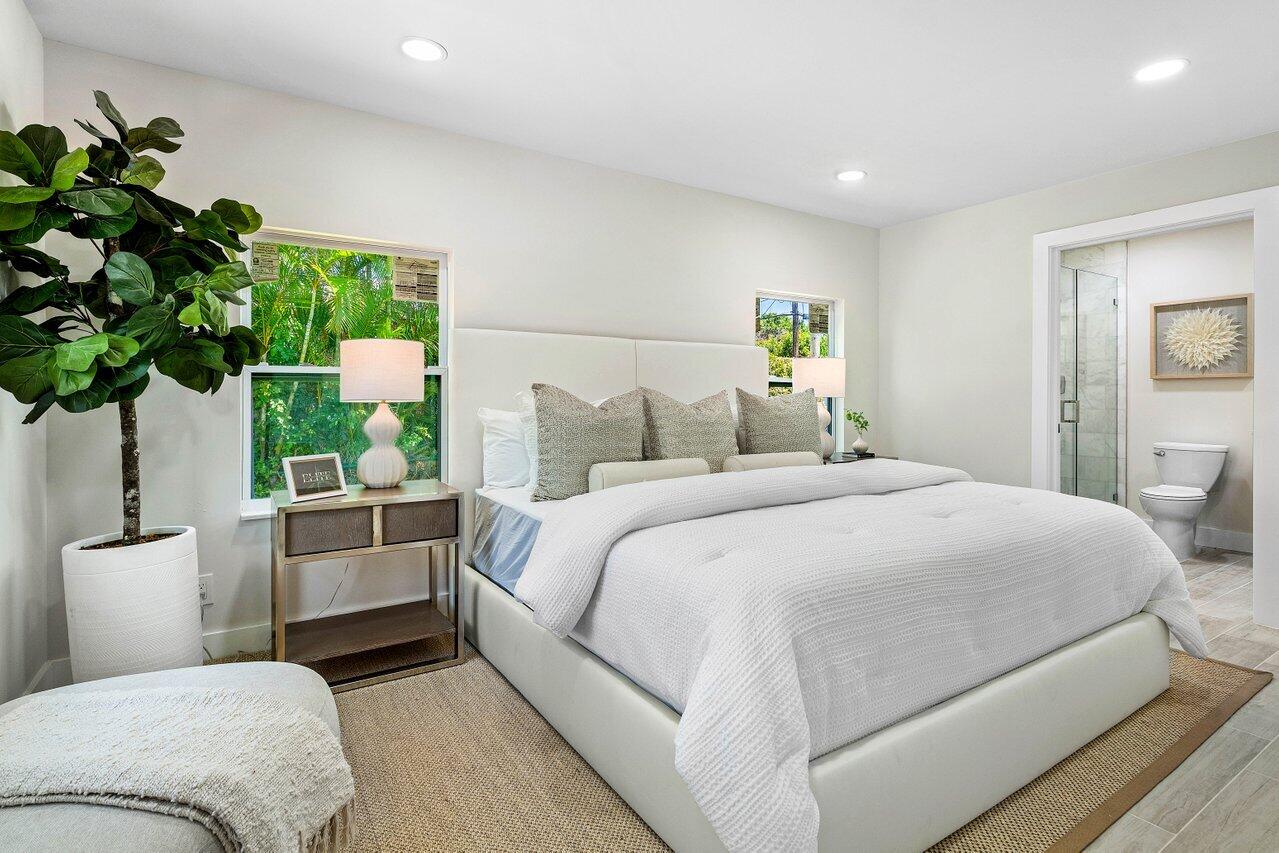 5497 North Ocean Boulevard Ocean Ridge, FL 33435 - Photo 15 of 33 a bedroom with a large bed and a potted plant