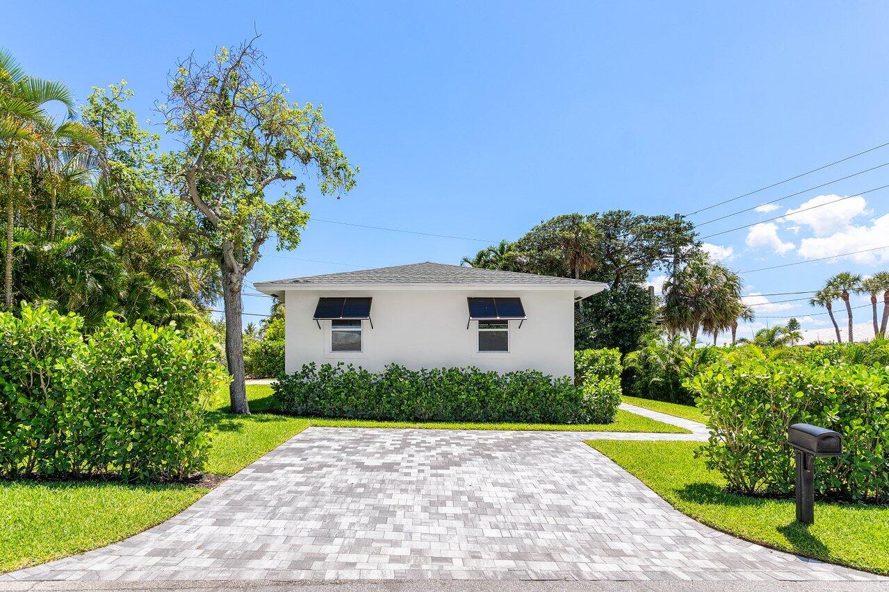 5497 North Ocean Boulevard Ocean Ridge, FL 33435 - Photo 23 of 33 a front view of a house with a yard and garage
