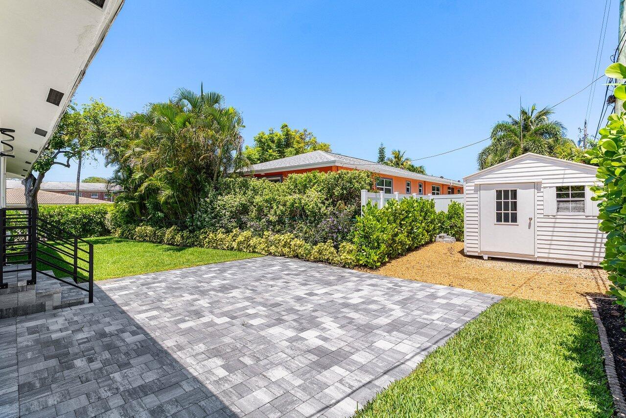 5497 North Ocean Boulevard Ocean Ridge, FL 33435 - Photo 26 of 33 a view of a house with a yard and potted plants