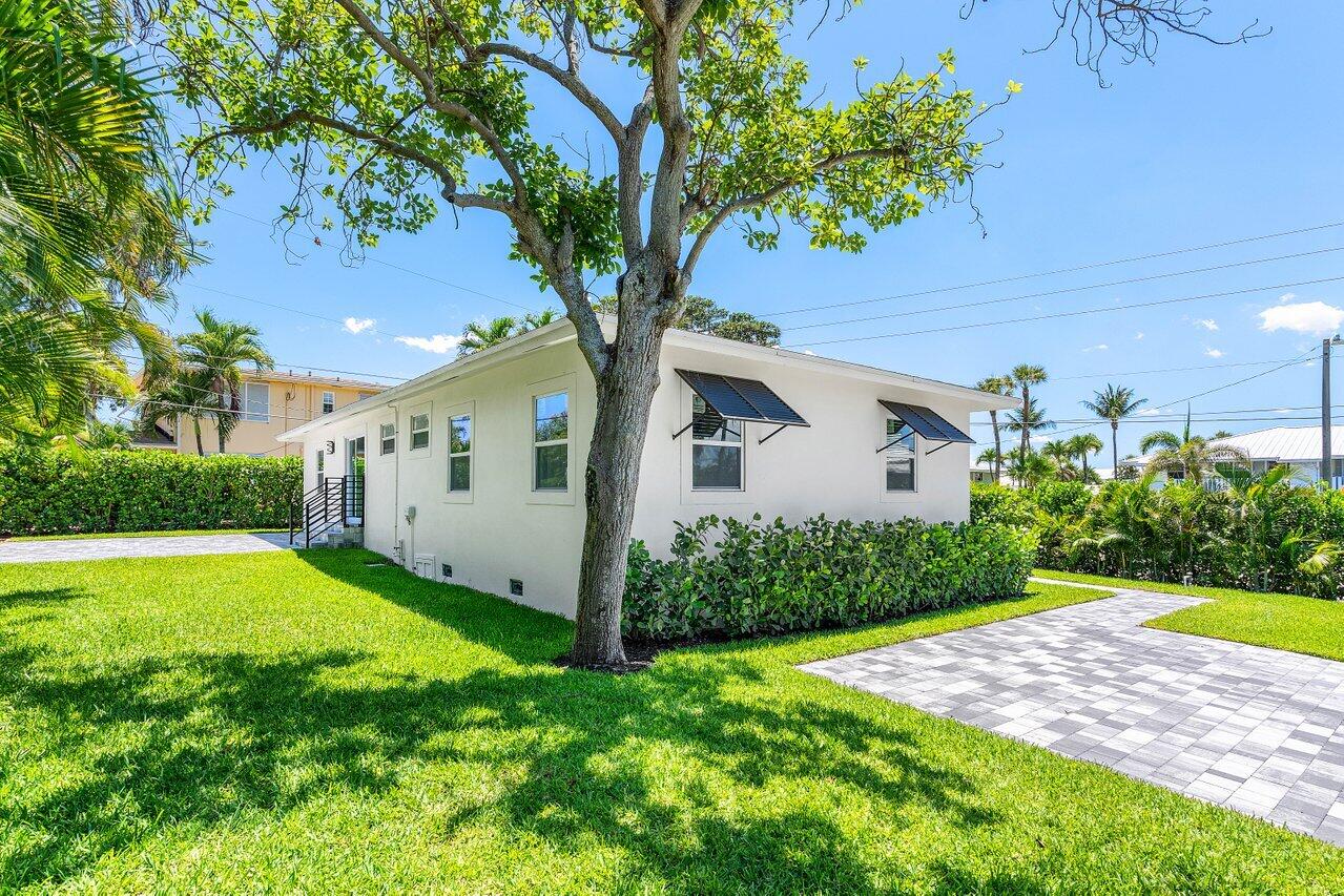 5497 North Ocean Boulevard Ocean Ridge, FL 33435 - Photo 28 of 33 a view of a backyard with potted plants and large trees