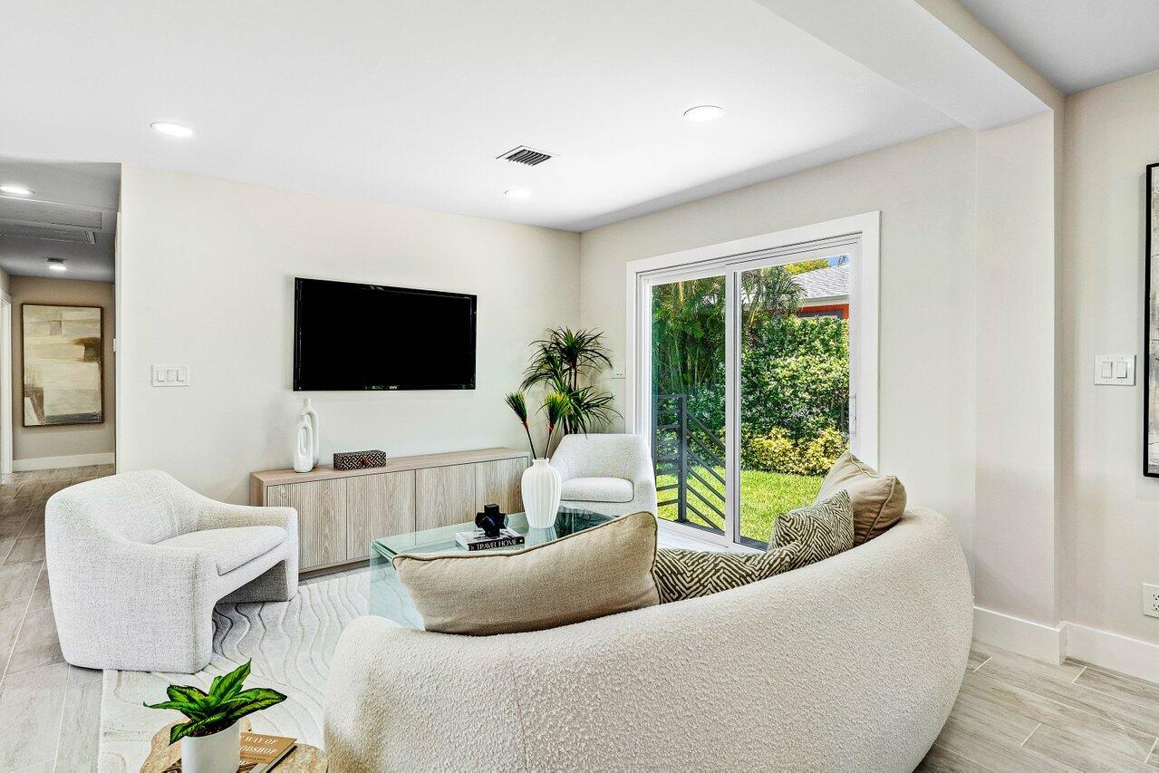 5497 North Ocean Boulevard Ocean Ridge, FL 33435 - Photo 6 of 33 a living room with furniture a flat screen tv and a large window