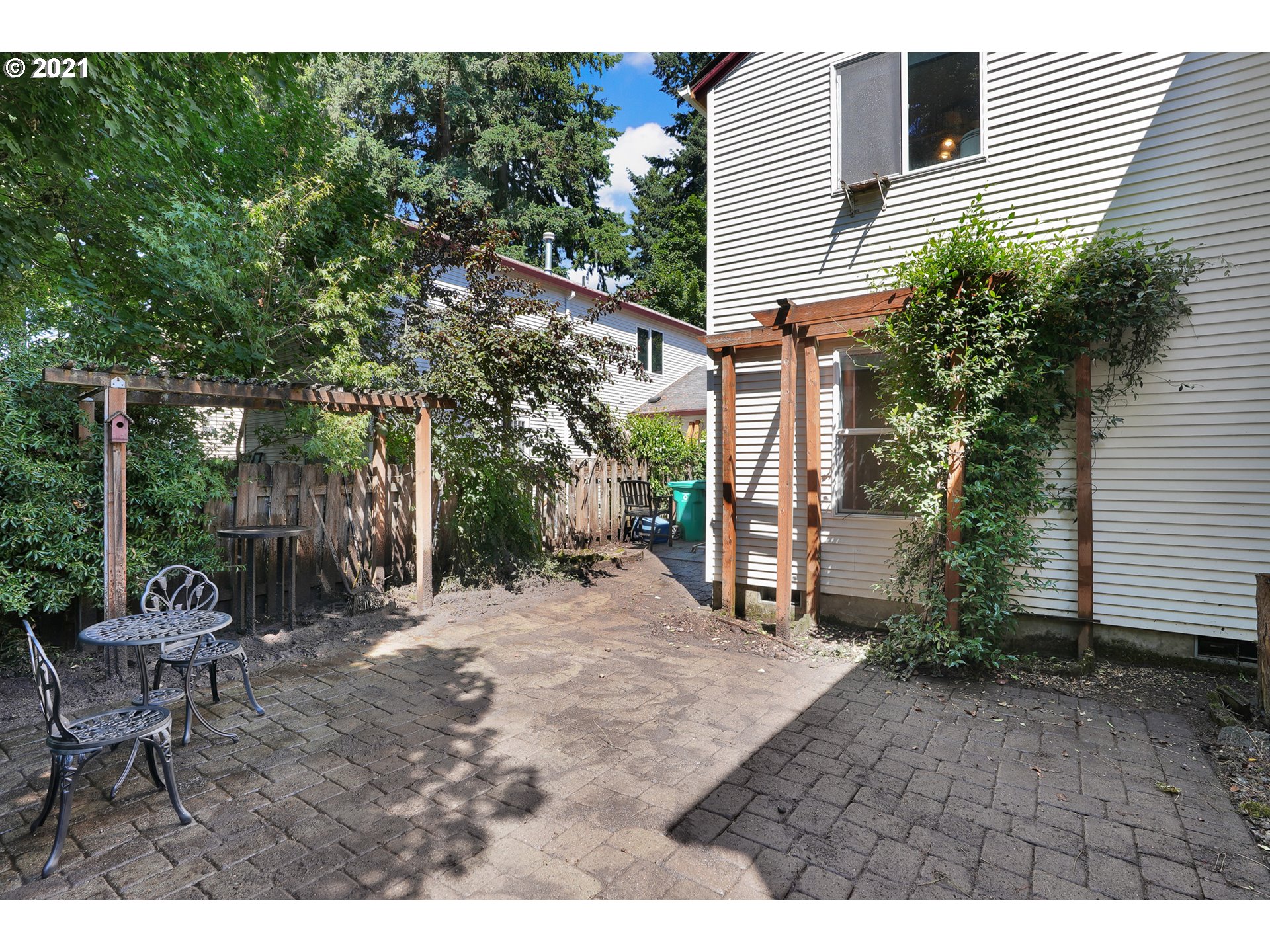 12648 Southeast Foster Road, Unit 10B Portland, OR 97236 - Photo 13 of 22 a backyard of a house with fountain and outdoor seating