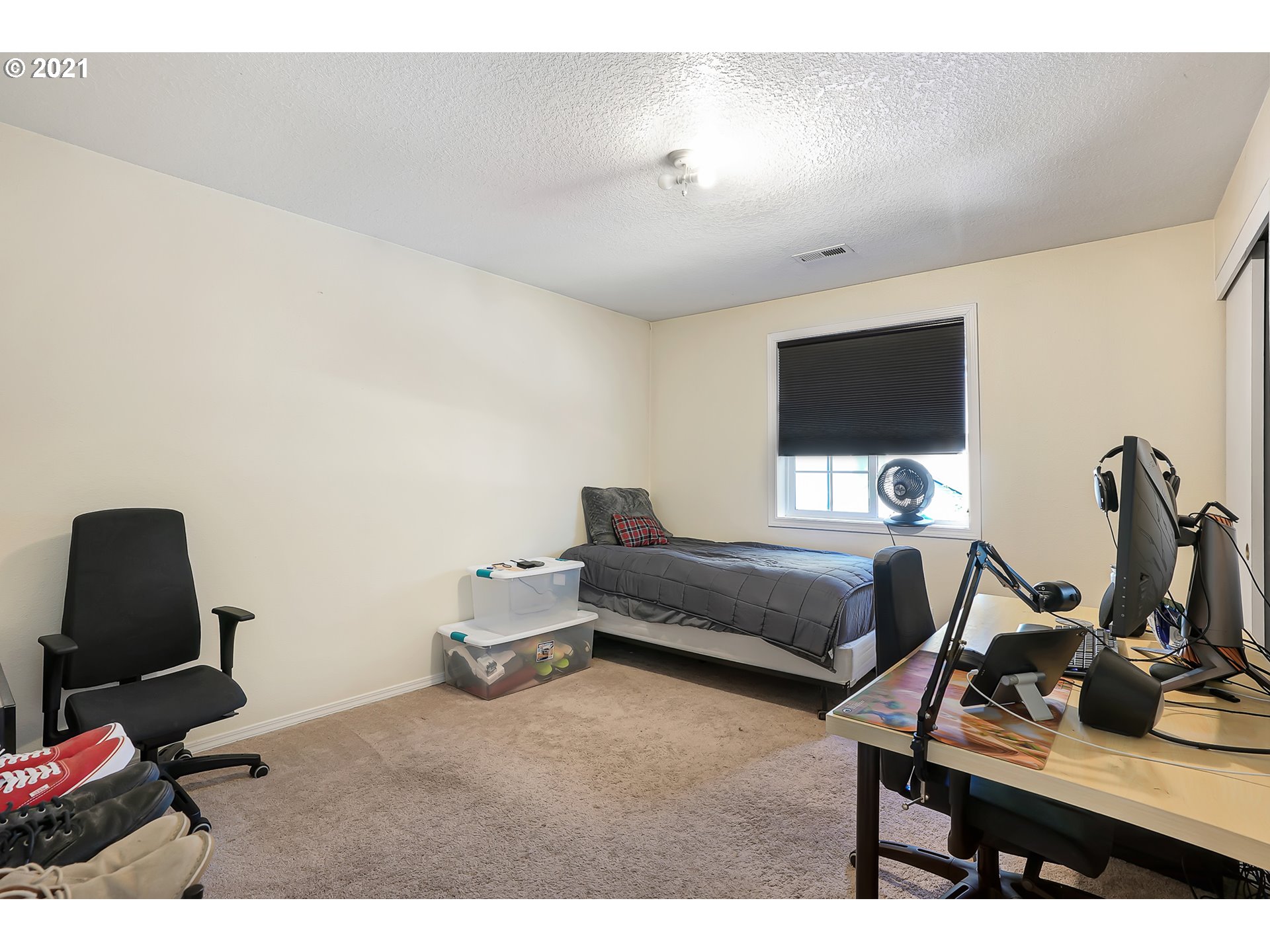 12648 Southeast Foster Road, Unit 10B Portland, OR 97236 - Photo 16 of 22 a bedroom with furniture and a flat screen tv