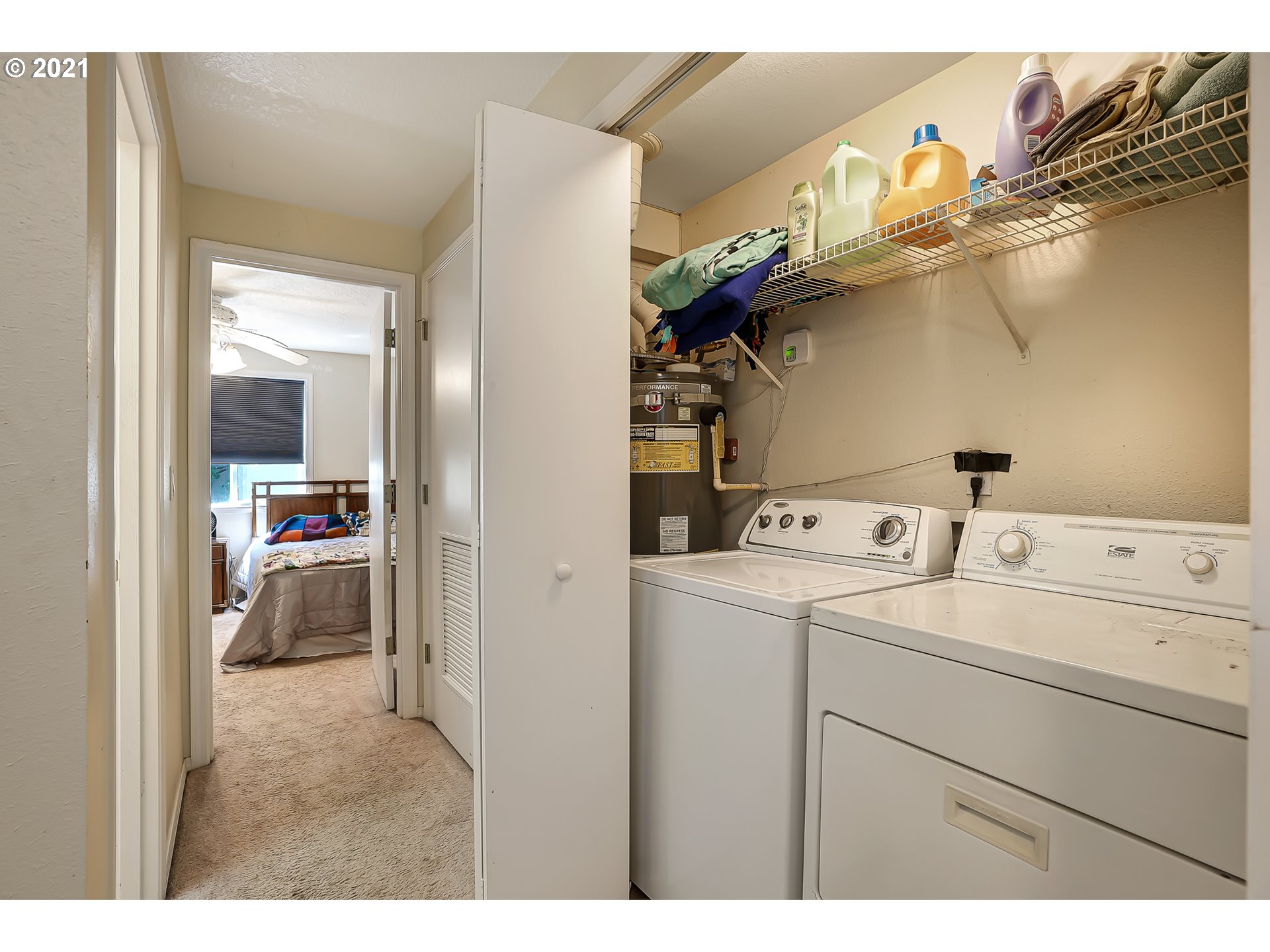 12648 Southeast Foster Road, Unit 10B Portland, OR 97236 - Photo 19 of 22 a view of washer and dryer with bathroom in the background