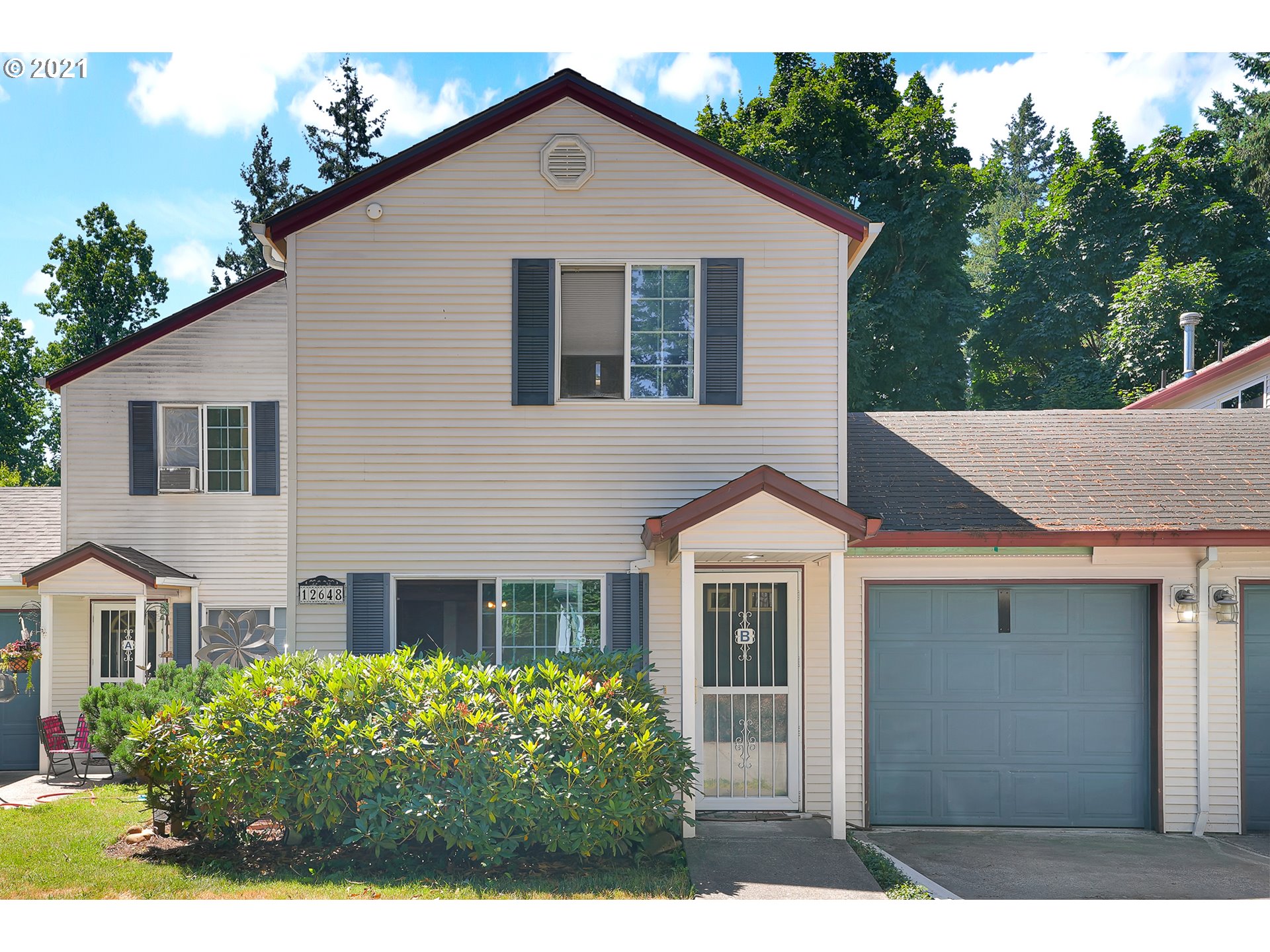 12648 Southeast Foster Road, Unit 10B Portland, OR 97236 - Photo 2 of 22 a front view of a house with garden
