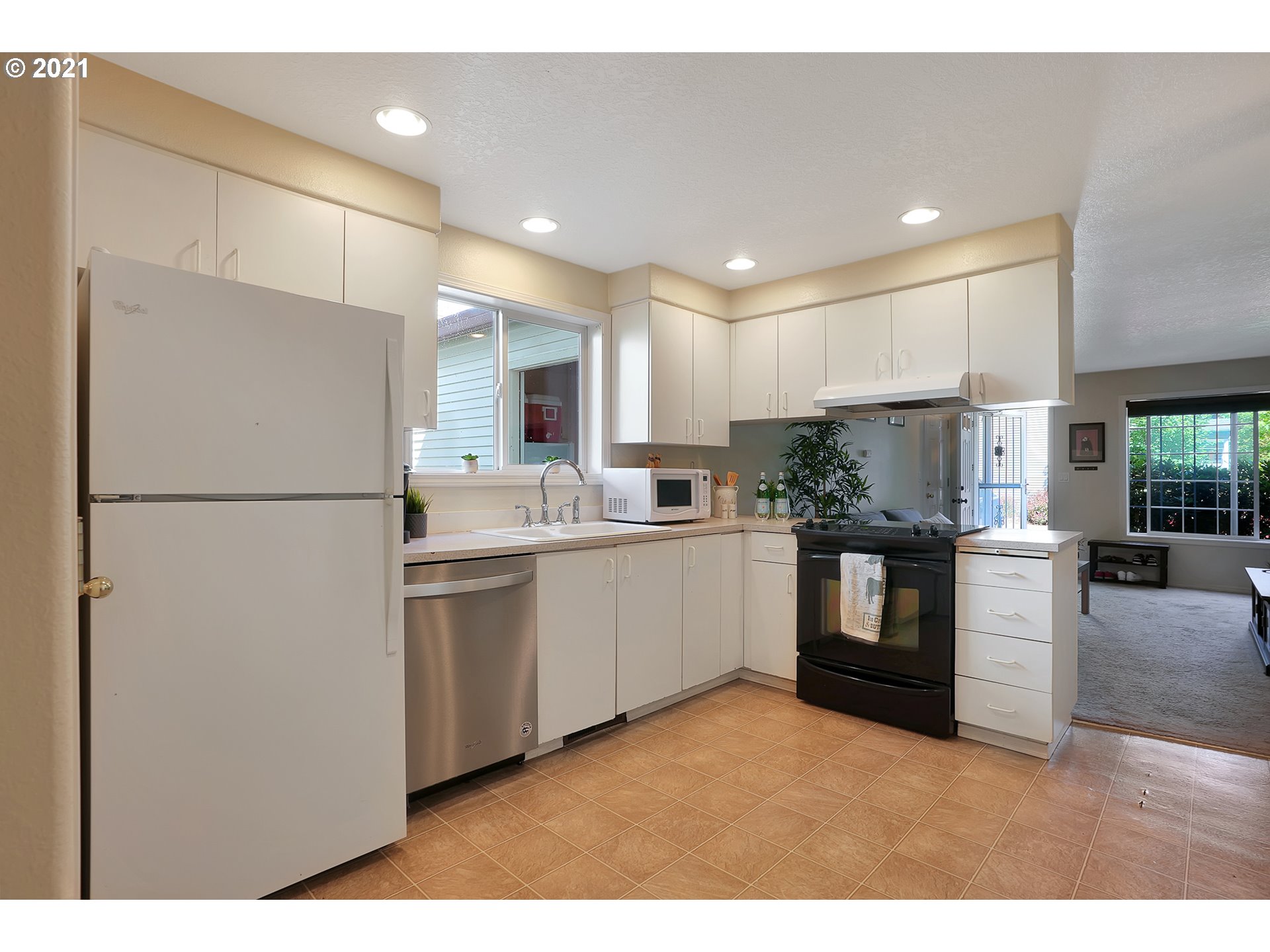 12648 Southeast Foster Road, Unit 10B Portland, OR 97236 - Photo 8 of 22 a kitchen with refrigerator and cabinets