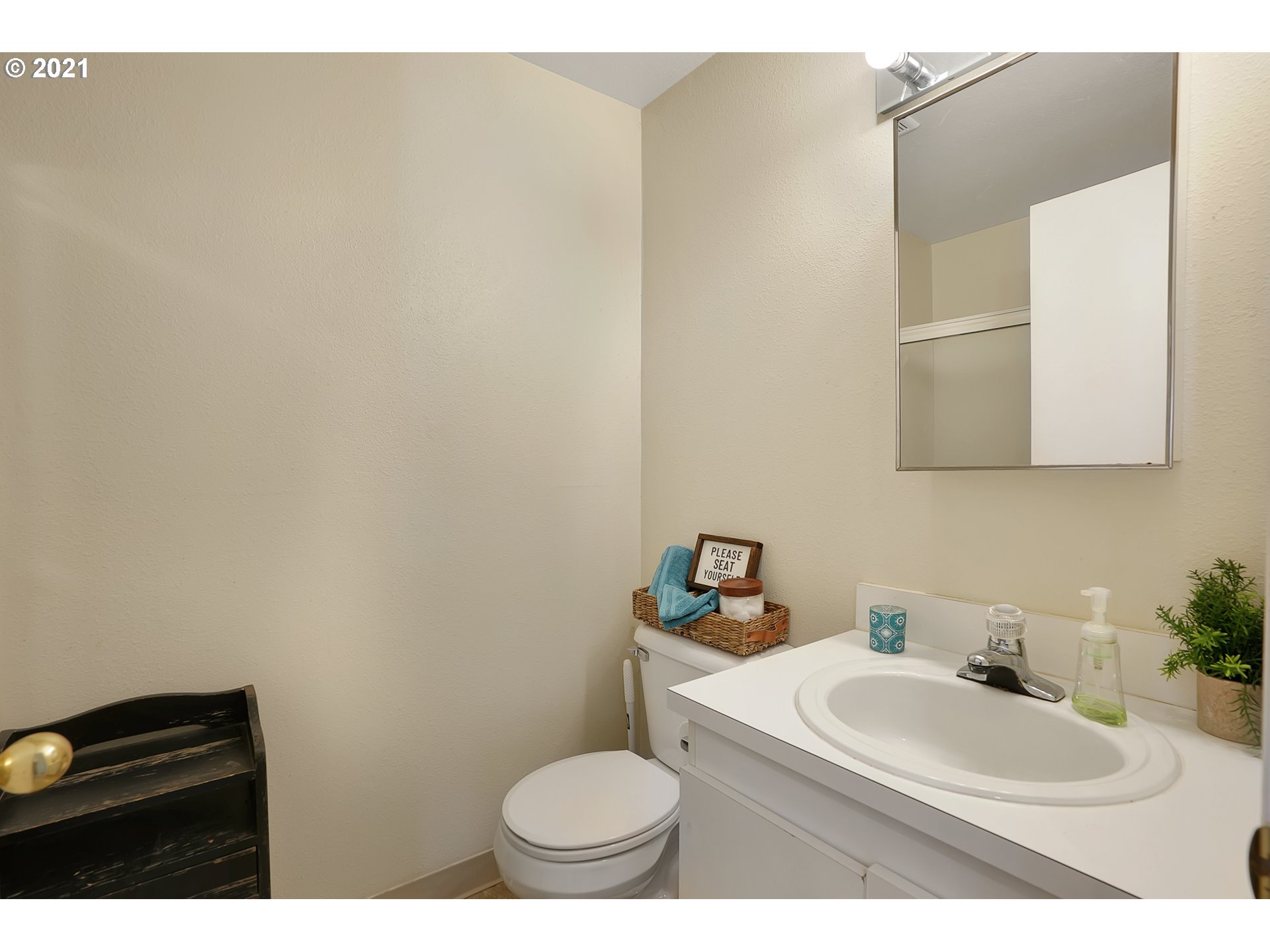 12648 Southeast Foster Road, Unit 10B Portland, OR 97236 - Photo 10 of 22 a bathroom with a sink a toilet and mirror