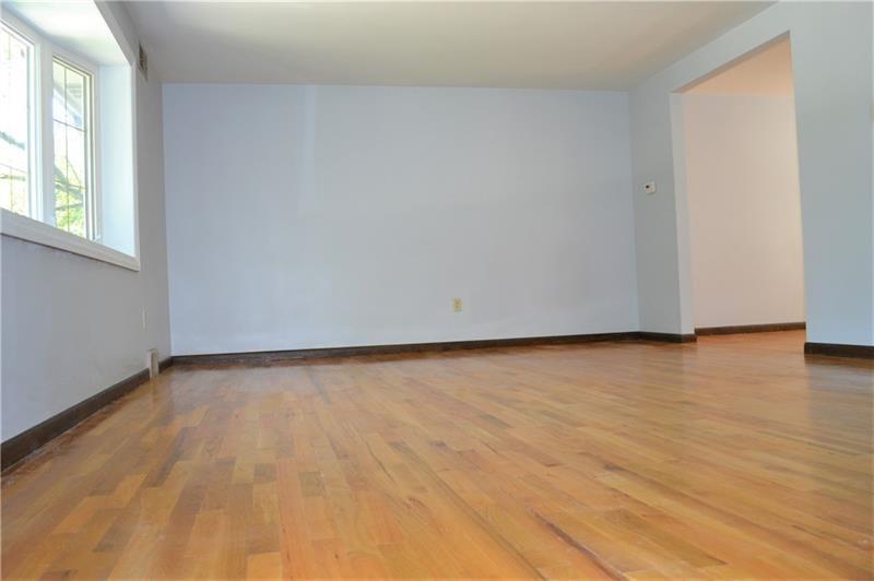 2108 Beulah Road Pittsburgh, PA 15235 - Photo 11 of 25 Freshly painted walls with a neutral palette are very inviting....The genuine hardwood floors throughout the living room, dining room and all FOUR bedrooms have been beautifully refinished to a gorgeous glossy finish!