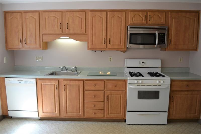 2108 Beulah Road Pittsburgh, PA 15235 - Photo 13 of 25 The eat-in kitchen features lots of cabinet space. A full suite of appliances includes a gas stove, dishwasher, refrigerator and microwave.