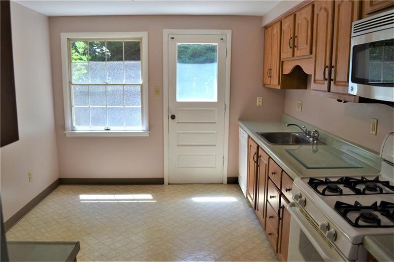 2108 Beulah Road Pittsburgh, PA 15235 - Photo 15 of 25 The back door in the kitchen leads to the rear patio and level backyard---perfect for grilling at the connected gas grill....