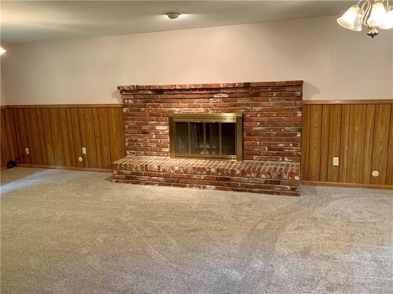 2108 Beulah Road Pittsburgh, PA 15235 - Photo 4 of 25 FAMILY ROOM: The generously sized 25x14 family room was just updated with brand new wall to wall carpeting and freshly painted after the removal of all of the wallpaper!