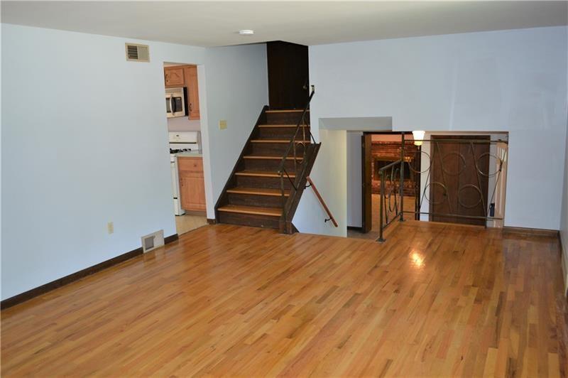 2108 Beulah Road Pittsburgh, PA 15235 - Photo 10 of 25 Another view of the living room, looking down to the family room, laundry area and powder room...The staircase takes you up to the four bedrooms and two full bathrooms.