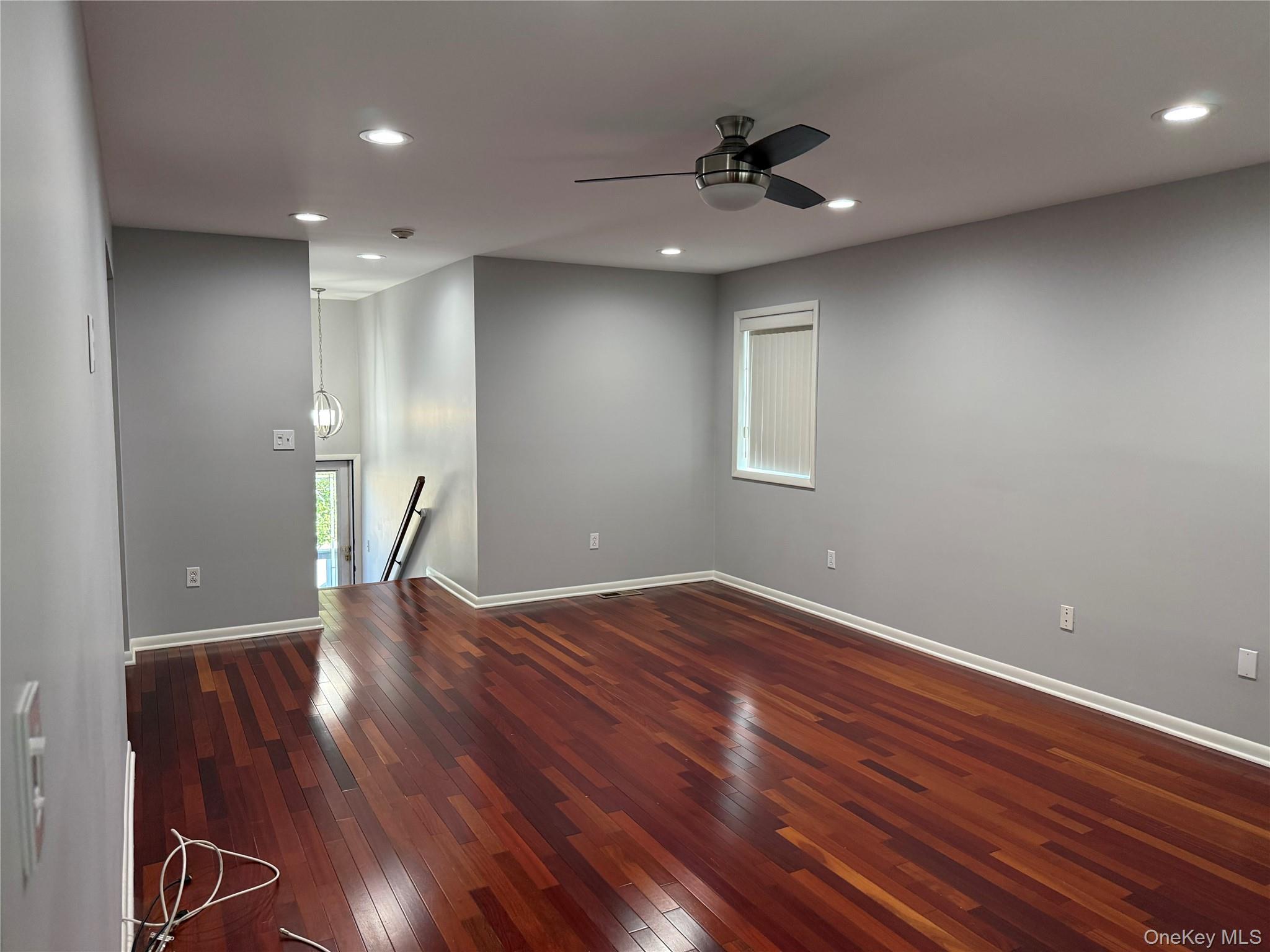 88 Eagle Ridge Way Nanuet, NY 10954 - Photo 6 of 16 a view of an empty room with wooden floor and a ceiling fan