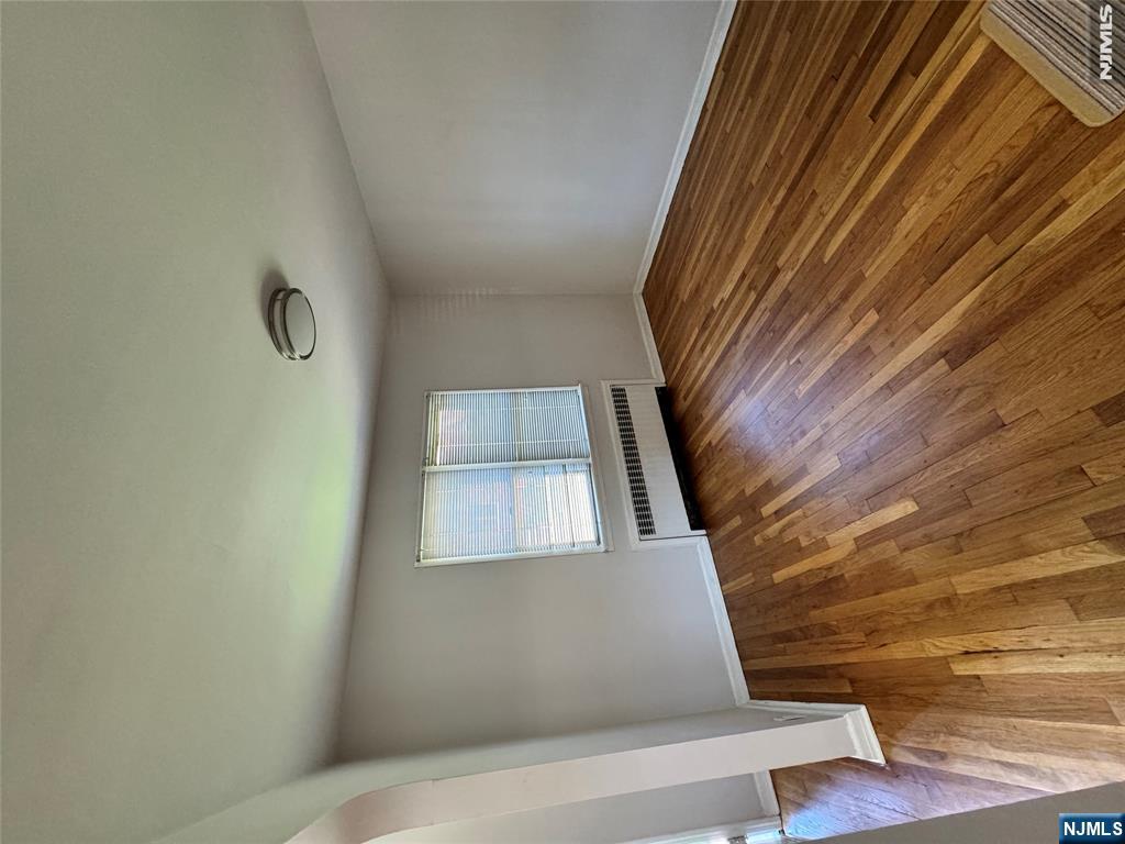 251 Fort Lee Road, Unit D Teaneck, NJ 07666 - Photo 4 of 14 an empty room with wooden floor and windows