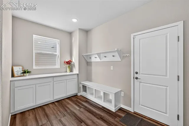 a hallway with cabinets and wooden floor