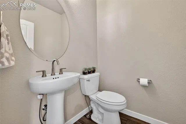 a bathroom with a sink toilet and a mirror