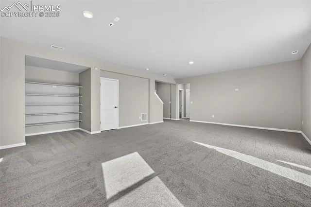 a view of an empty room with a closet